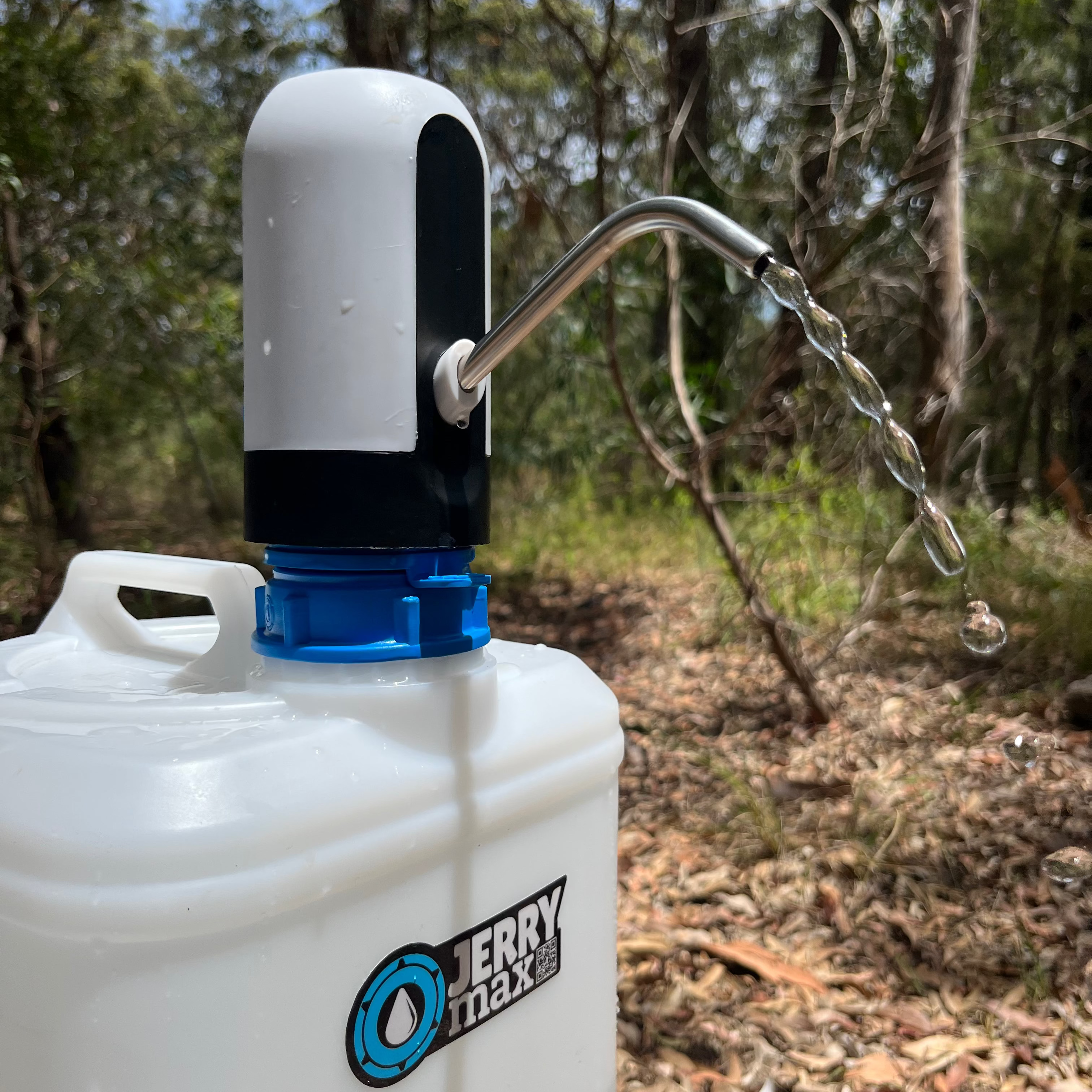 Water dispenser attached to a white container with water flowing outdoors.